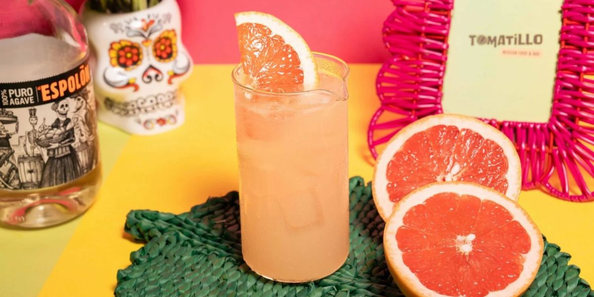 Grapefruit cocktail with tequila bottle decor